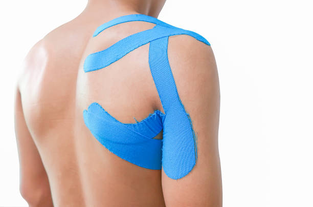 Blue kinesiology taping on man shoulder on white background